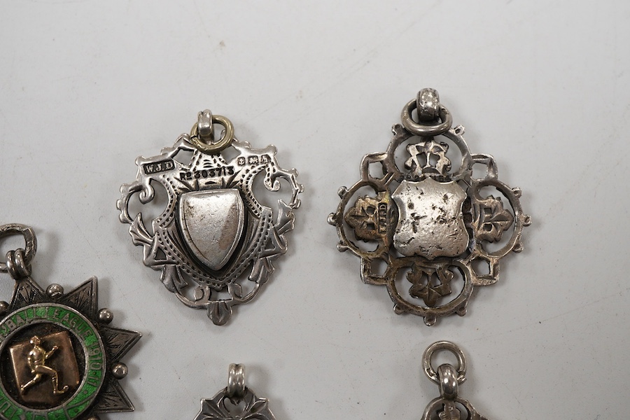 Five assorted early 20th century silver medals, including enamelled 'Luton District Football League, 1910/11', diameter 28mm.